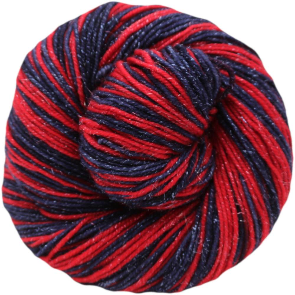 Red and navy yarn ball on a white background