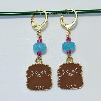 Dog-shaped earrings with blue beads on a white background