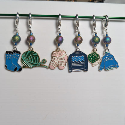 Set of colorful knitting stitch markers on a white background
