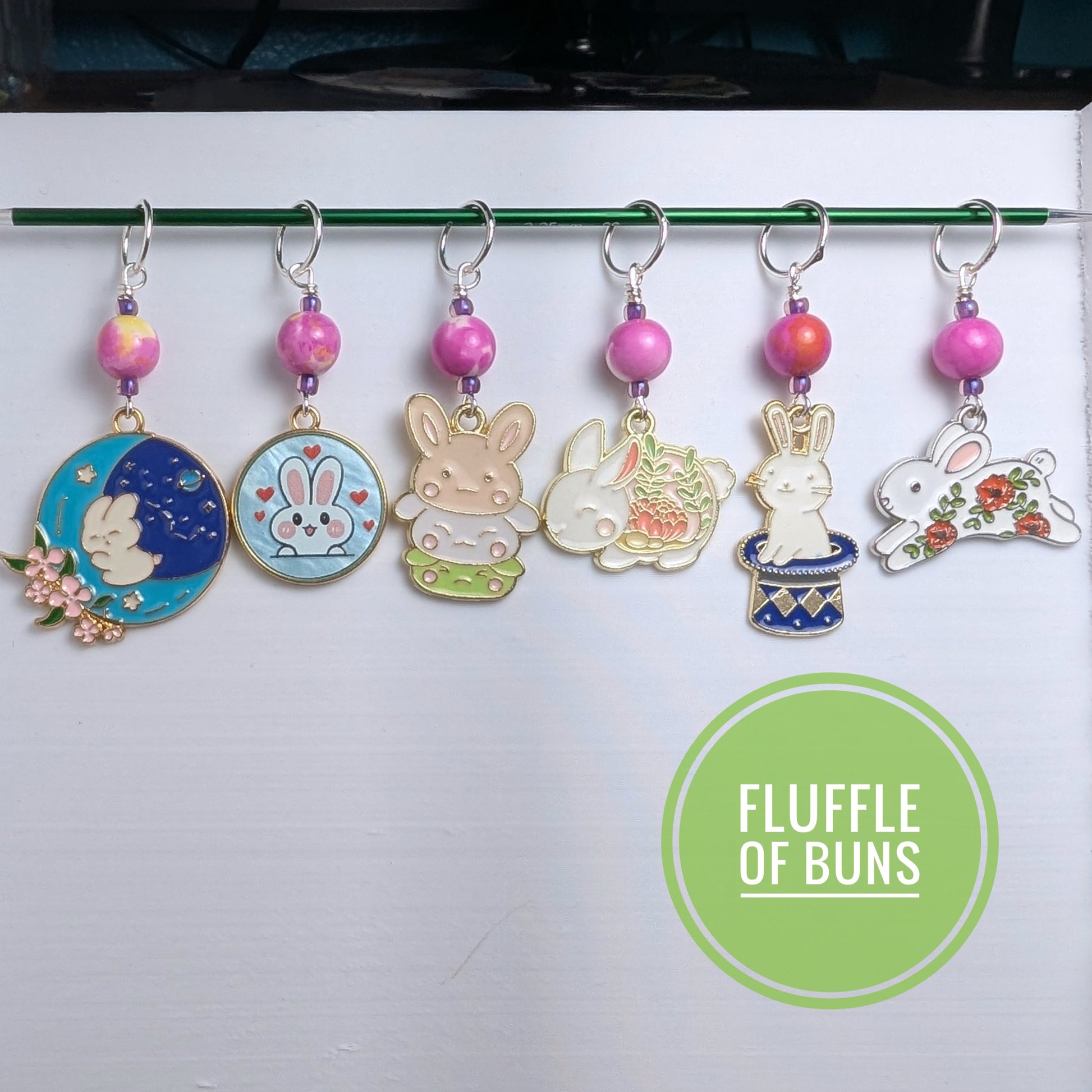 Set of colorful keychains with bunny designs on a white background, branded 'Fluffle of Buns'.